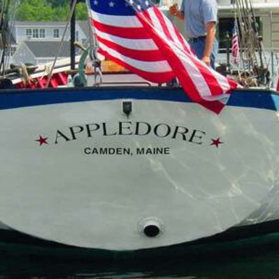 The stern of a boat named "Appledore" with an American flag and the text "Camden, Maine."
